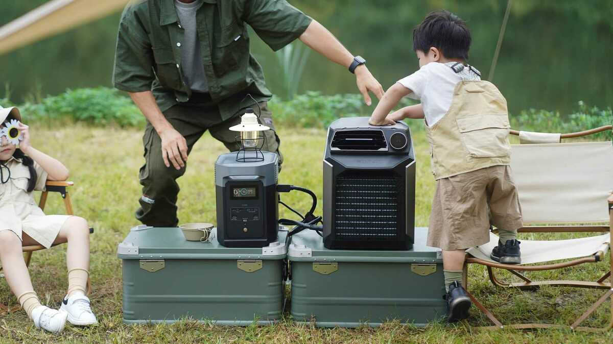 père et fils en train d'utiliser une batterie nomade en extérieur