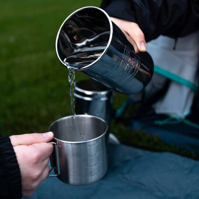 Purificateur d'eau 1L BRITISH BERKEFELD CARTOUCHE ULTRA STERASYL Filtre gravite BBone. Versement de l'eau dans une tasse.